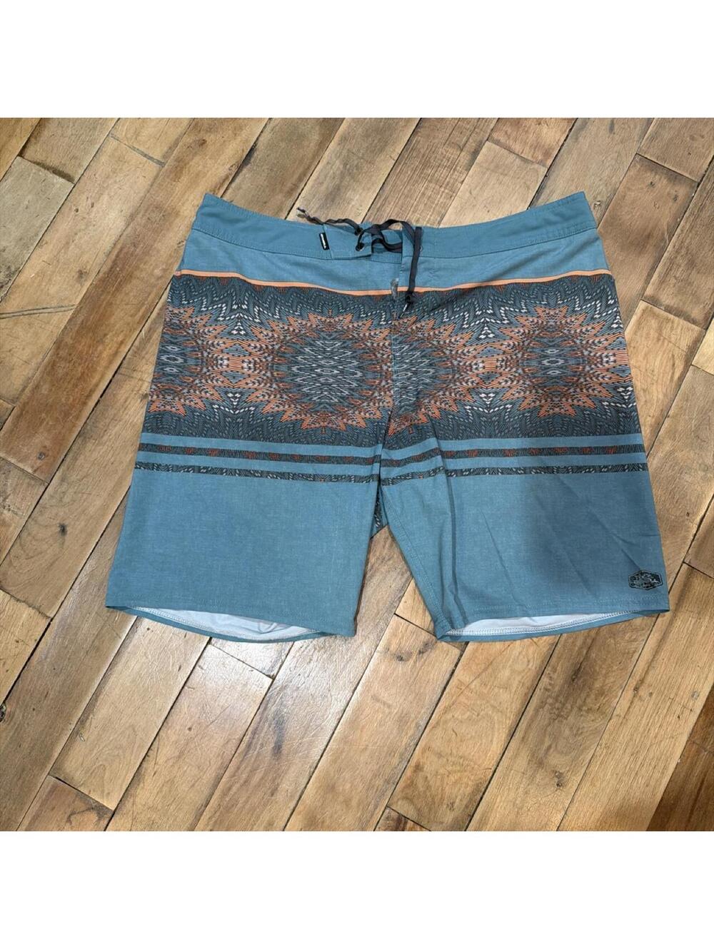 Y2K Billabong board shorts with orange and dark blue geometric mandala pattern